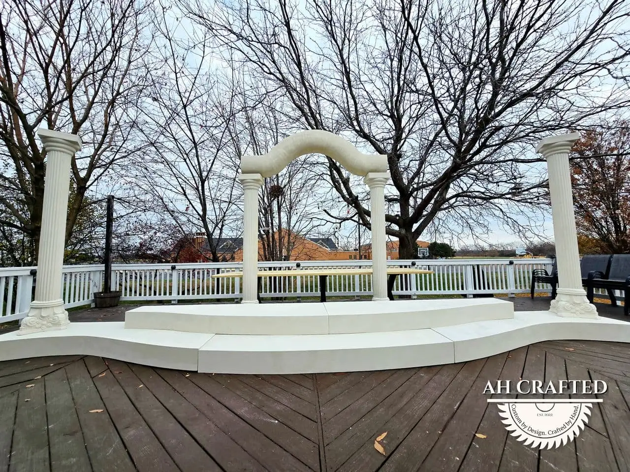 Classical Pillar Arch & Stage — a custom arch & contoured stage built by AH Crafted.