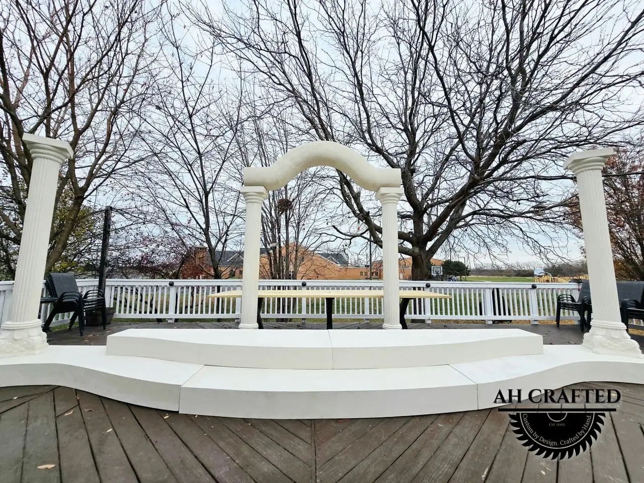Classical Pillar Arch & Stage — a custom arch & contoured stage built by AH Crafted.