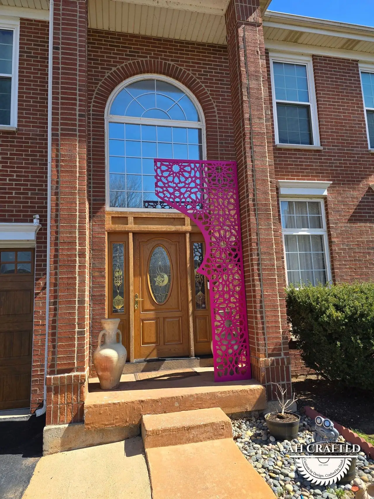 Rani Matrix Arch — rani-pink CNC cutout boxed panels forming a mihrab arch, built by AH Crafted.