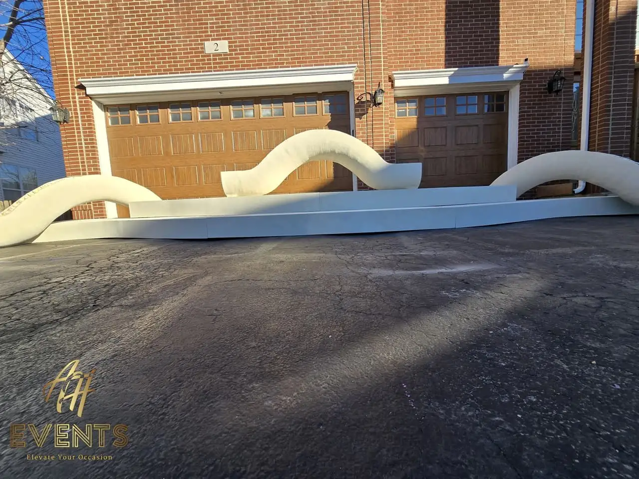 Classical Pillar Arch & Stage — a custom arch & contoured stage built by AH Crafted.