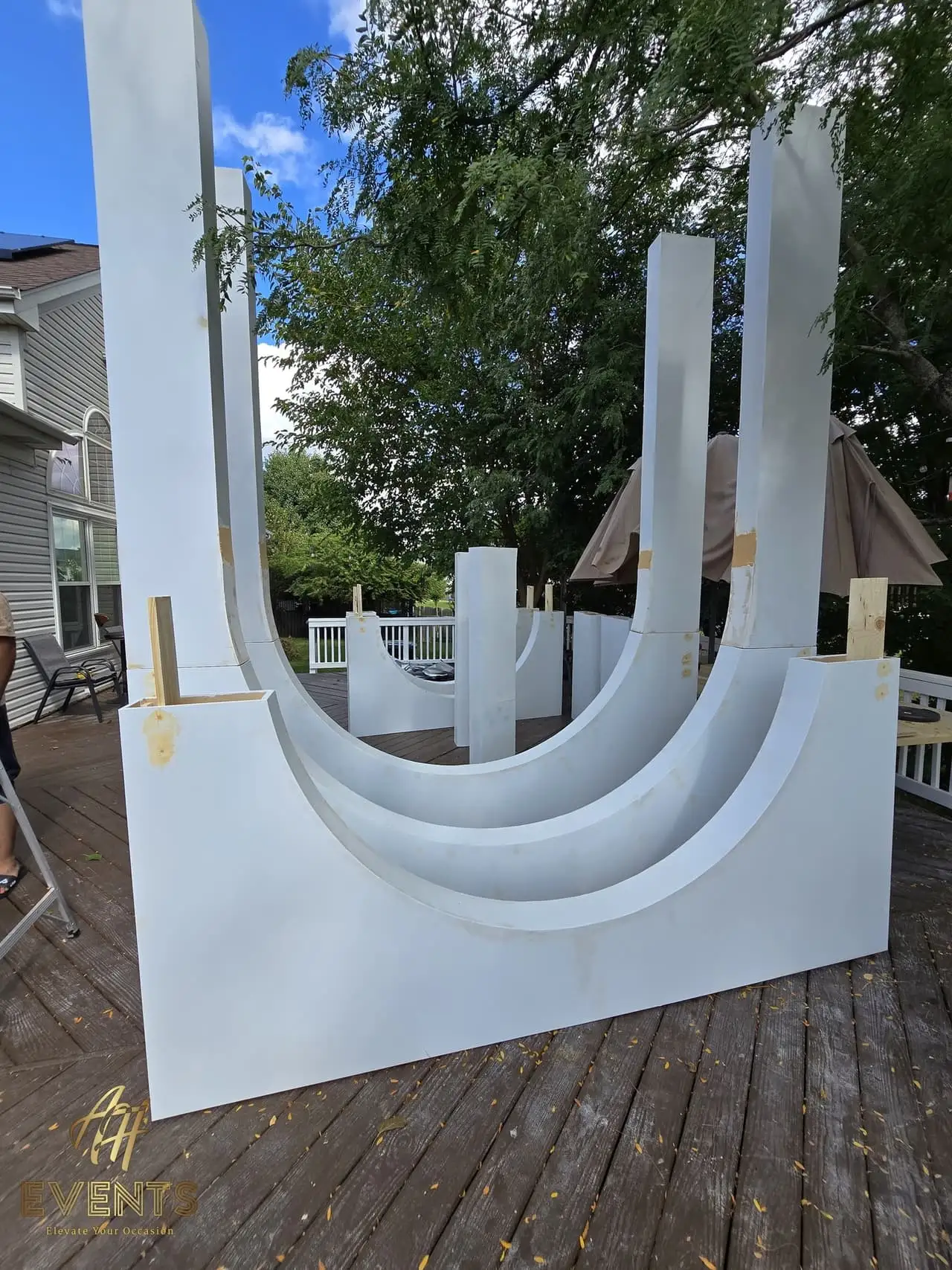 Volumetric Arc Suite — a custom sculptural backdrop built by AH Crafted.