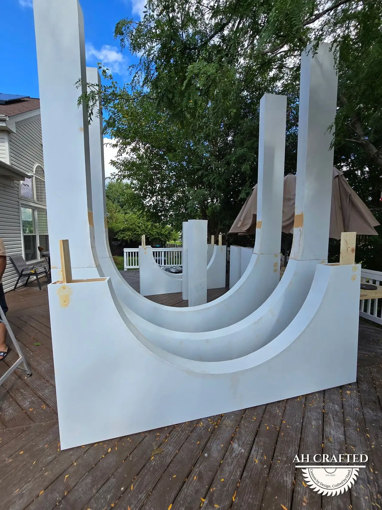 Volumetric Arc Suite — a custom sculptural backdrop built by AH Crafted.