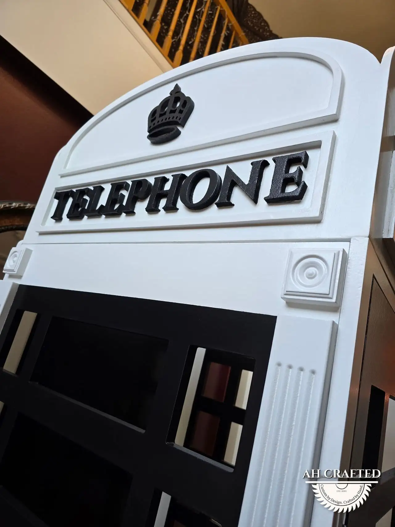 Low-angle detail of the raised TELEPHONE lettering and the crown crest above it.