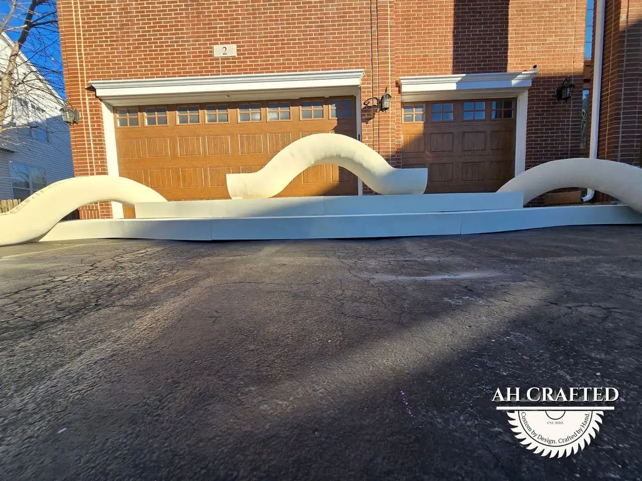 Classical Pillar Arch & Stage — a custom arch & contoured stage built by AH Crafted.