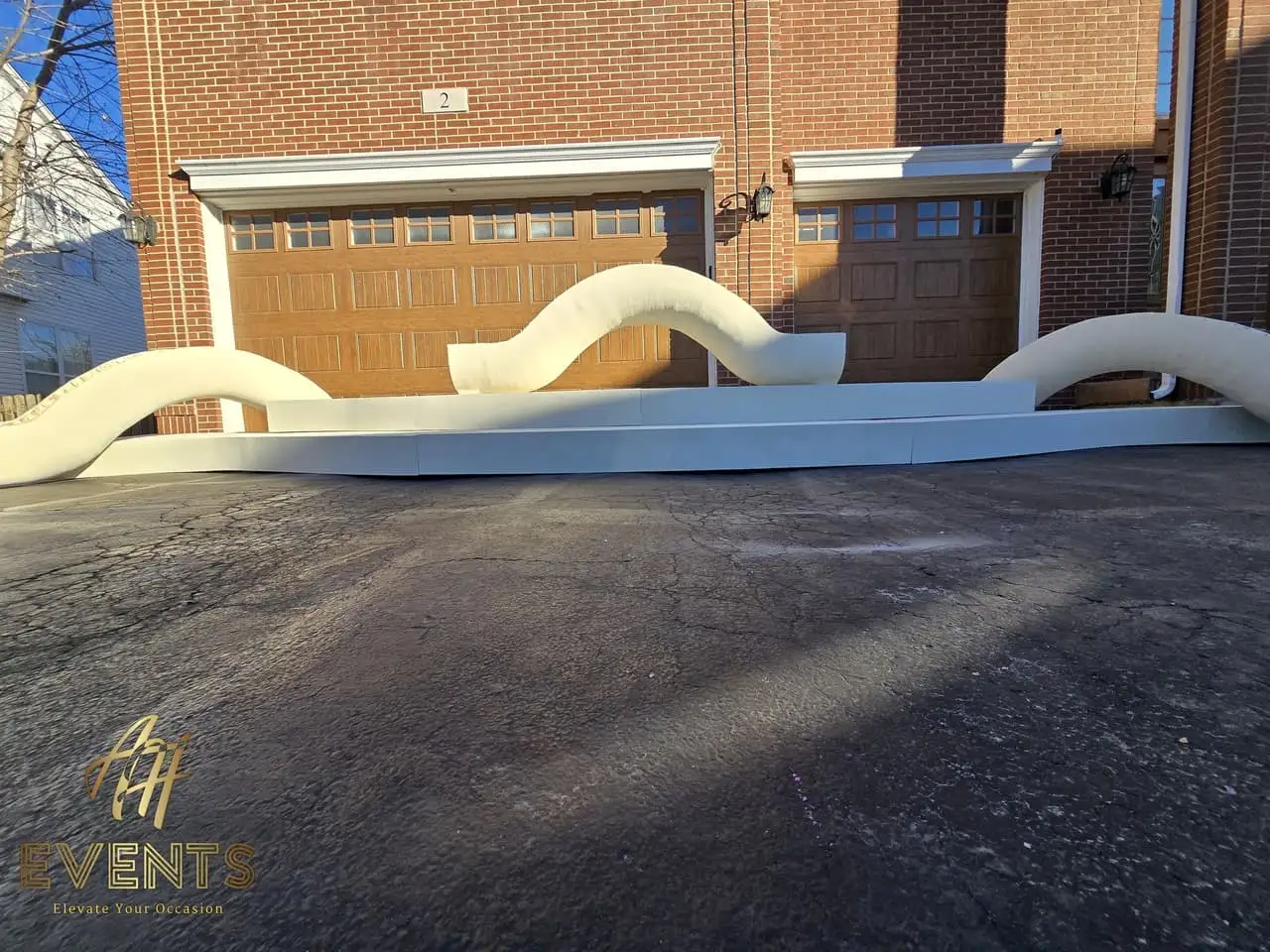 Classical Pillar Arch & Stage — a custom arch & contoured stage built by AH Crafted.