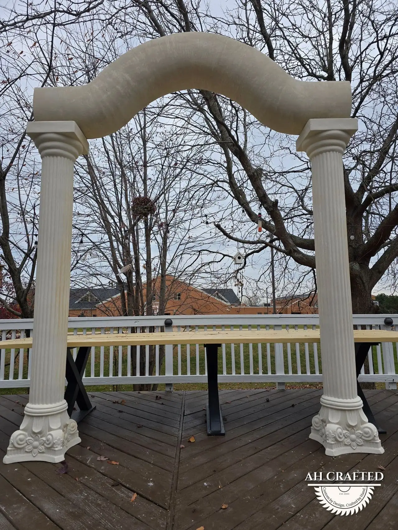 Classical Pillar Arch & Stage — a custom arch & contoured stage built by AH Crafted.