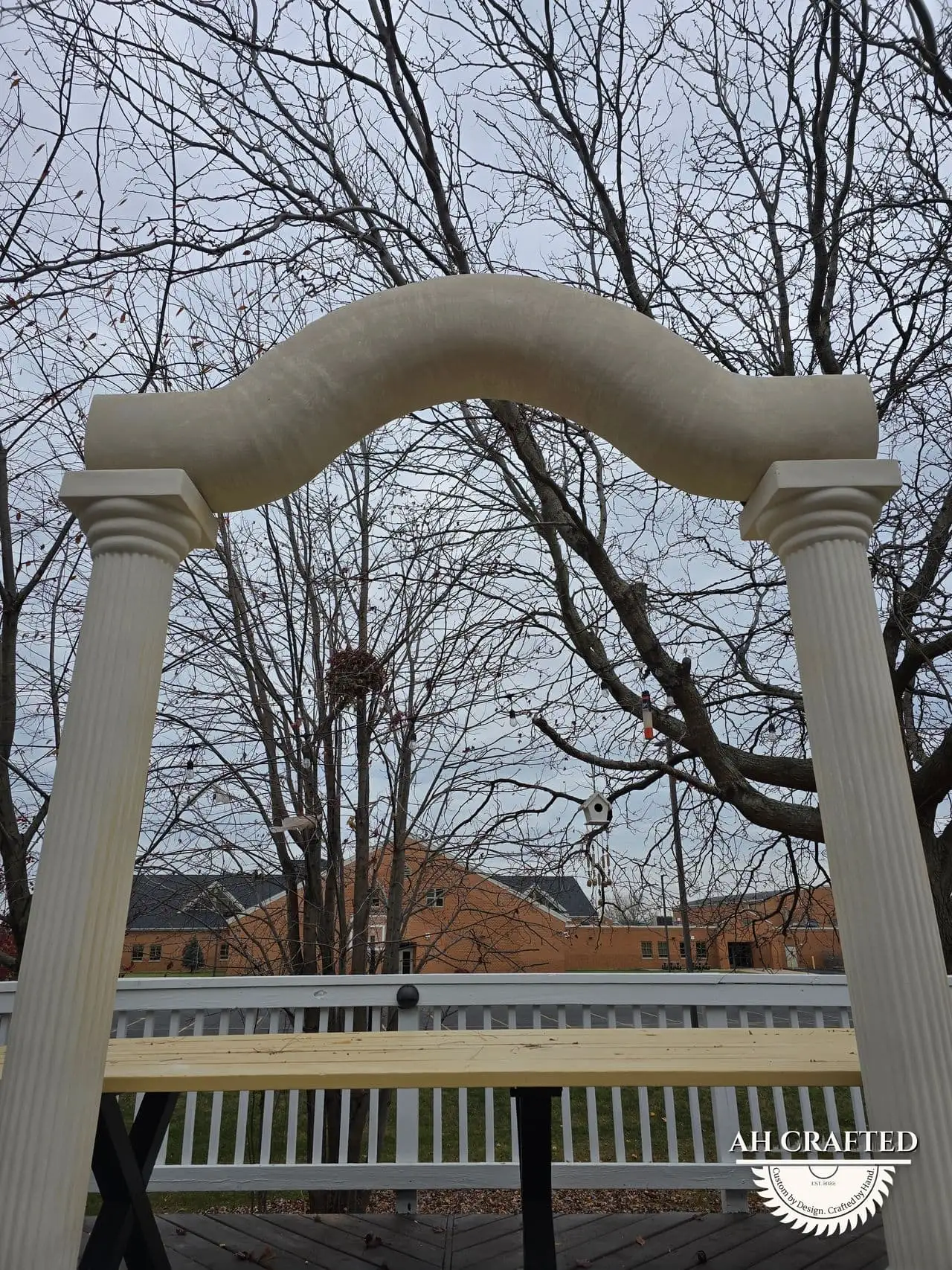Classical Pillar Arch & Stage — a custom arch & contoured stage built by AH Crafted.