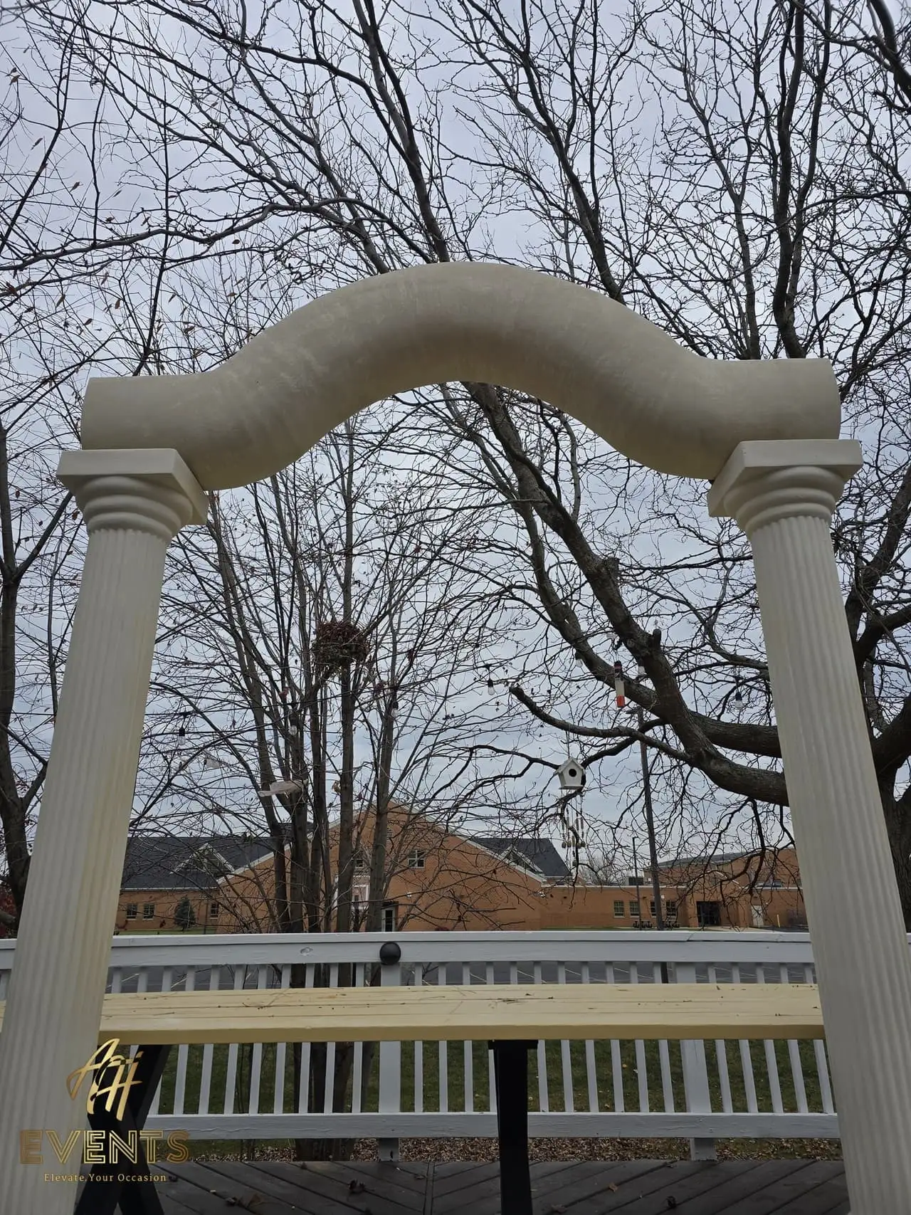 Classical Pillar Arch & Stage — a custom arch & contoured stage built by AH Crafted.