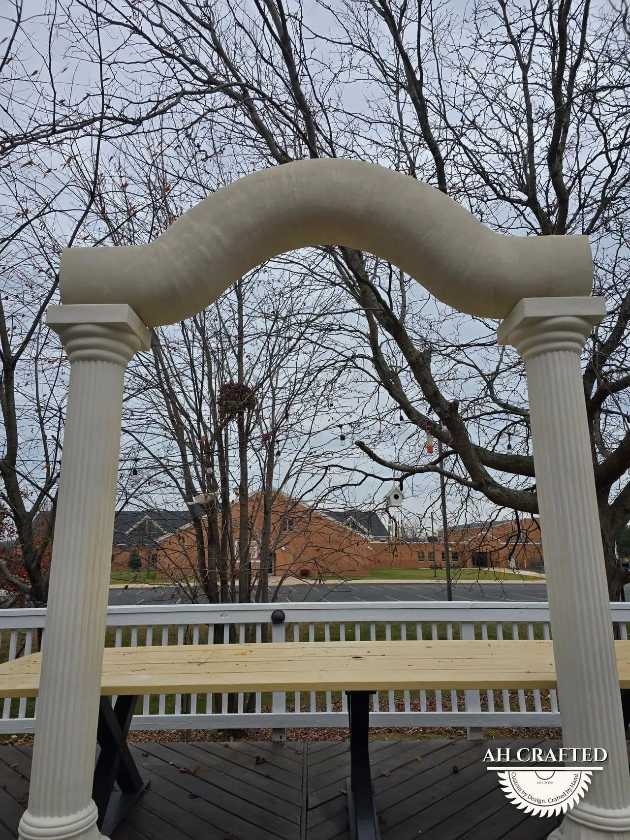 Classical Pillar Arch & Stage — a custom arch & contoured stage built by AH Crafted.