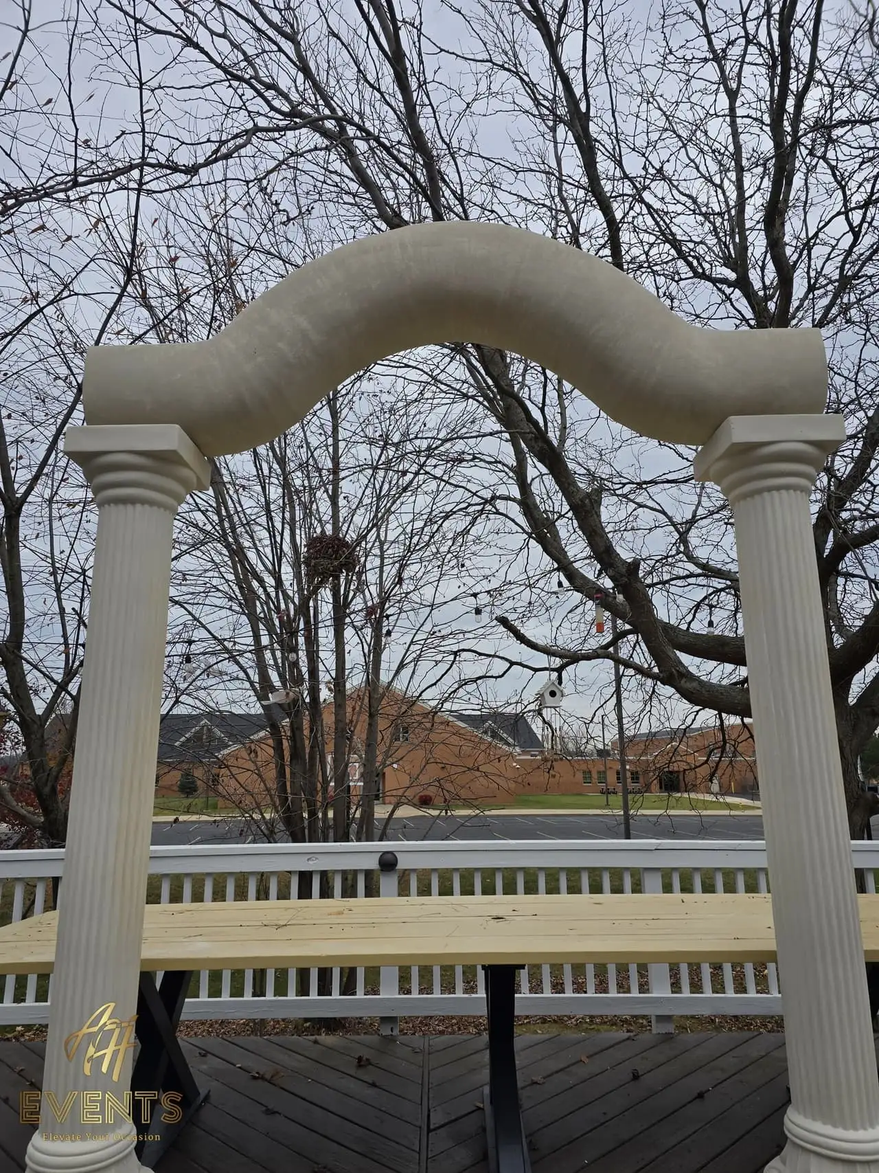 Classical Pillar Arch & Stage — a custom arch & contoured stage built by AH Crafted.