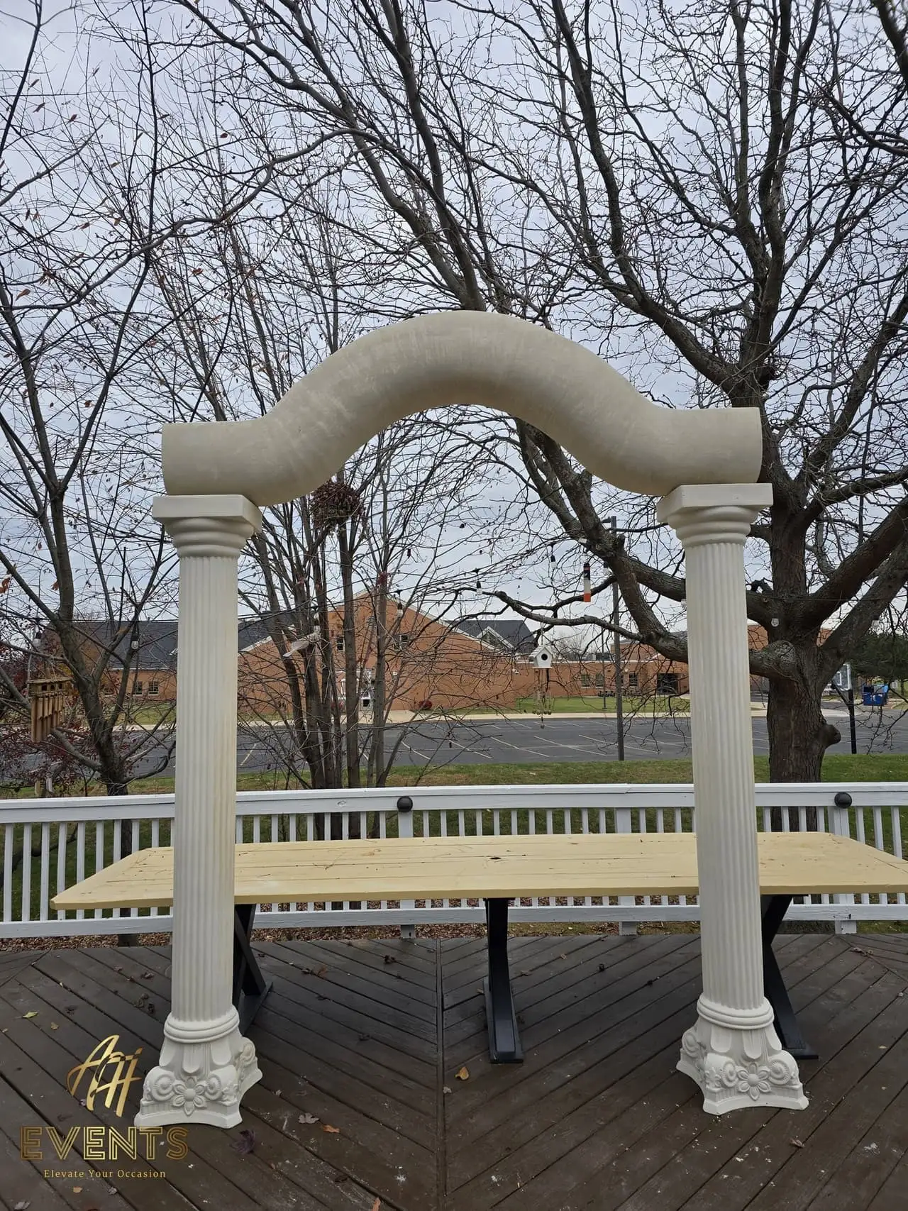 Classical Pillar Arch & Stage — a custom arch & contoured stage built by AH Crafted.
