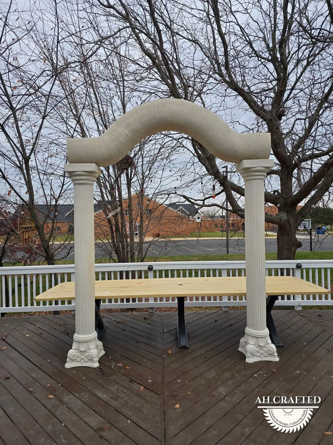 Classical Pillar Arch & Stage — a custom arch & contoured stage built by AH Crafted.