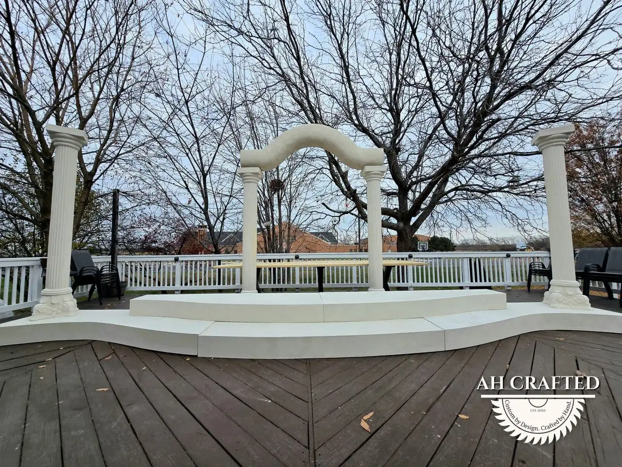 Classical Pillar Arch & Stage — a custom arch & contoured stage built by AH Crafted.