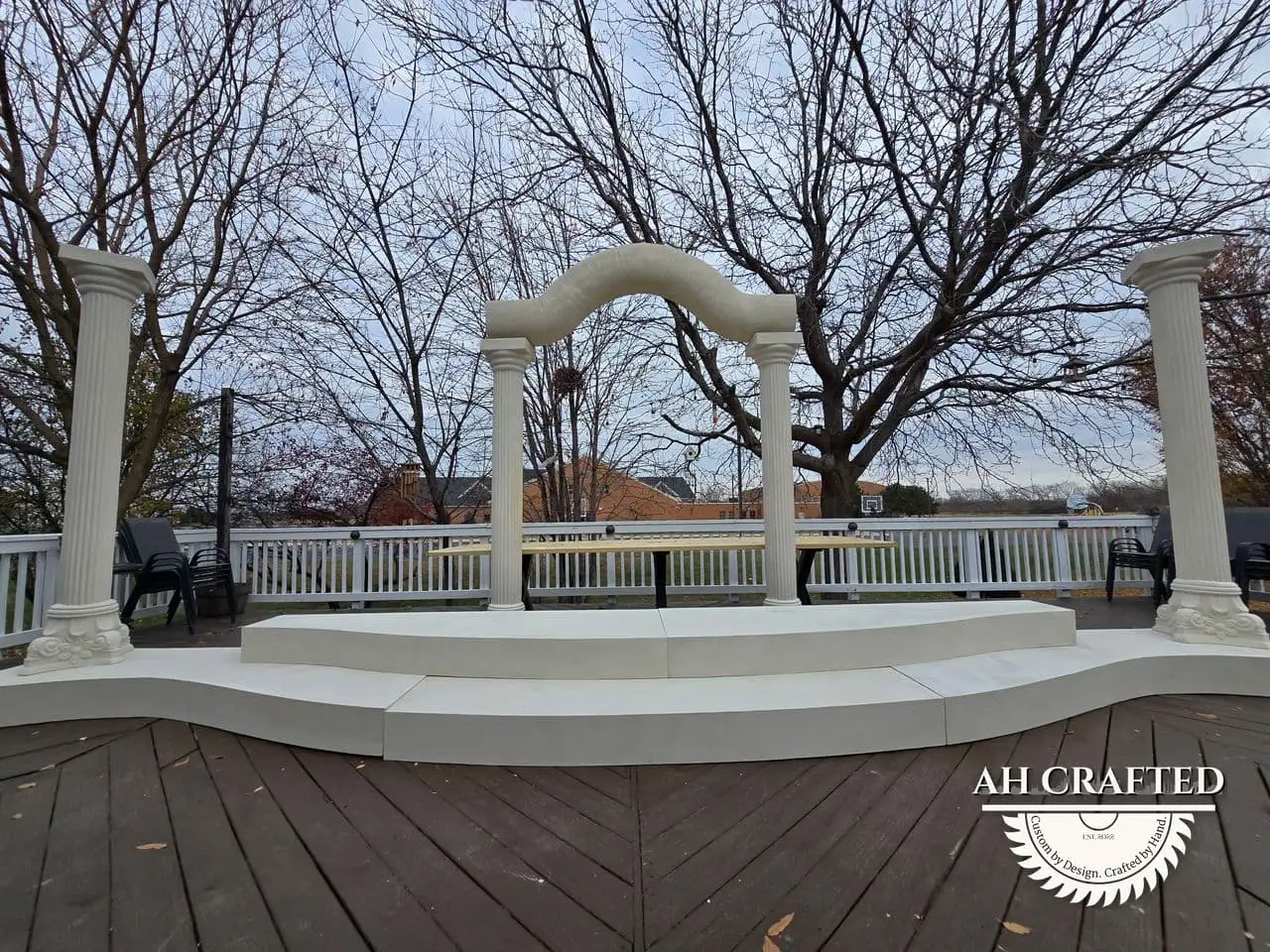 Classical Pillar Arch & Stage — a custom arch & contoured stage built by AH Crafted.