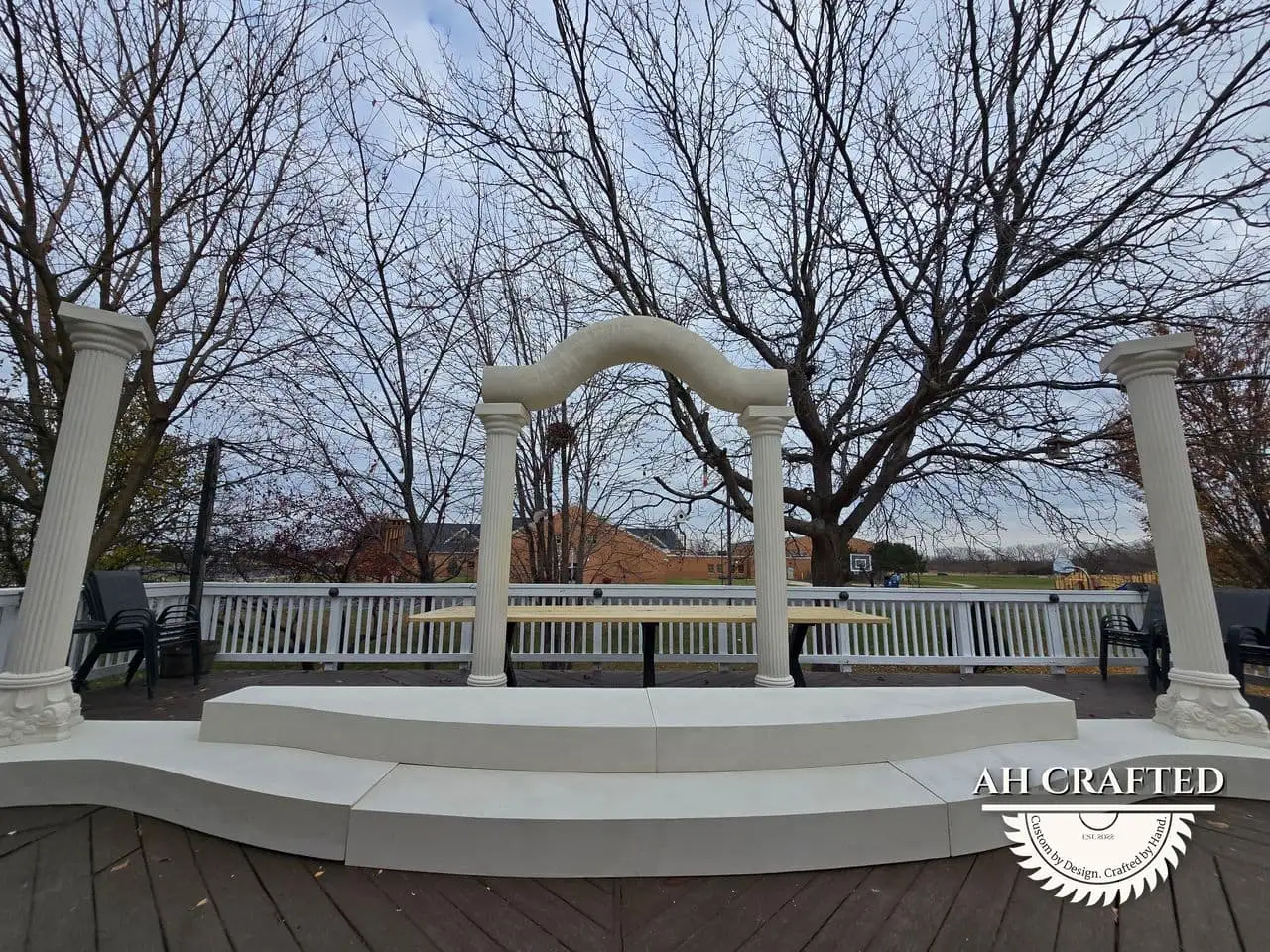 Classical Pillar Arch & Stage — a custom arch & contoured stage built by AH Crafted.